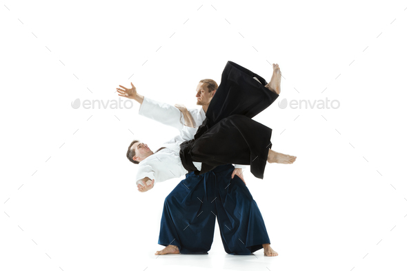 The two men fighting at Aikido training in martial arts school - Stock Photo - Images