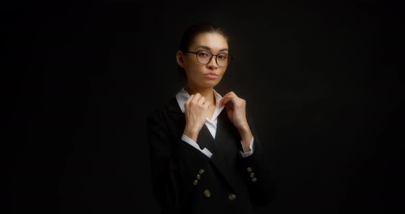 Beautiful Confident Business Woman Adjusts the Lapel on Her Jacket