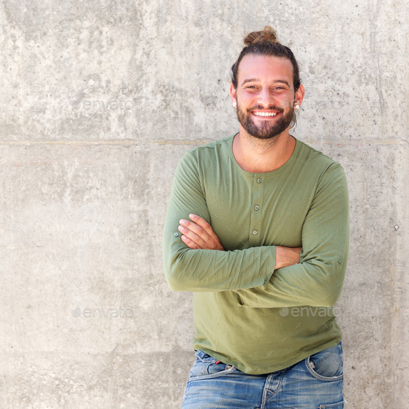 Cool guy smiling with arms crossed Stock Photo by mimagephotography