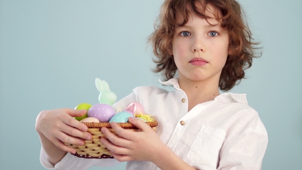 Curly Boy with an Easter Basket. First a Serious Look on His Face, Then He Laughs alt