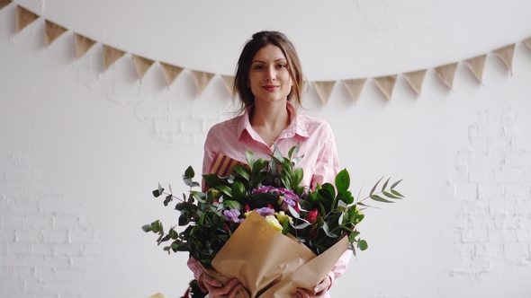 Portrait of Florist with Big Modern Bouquet of Different Flowers alt