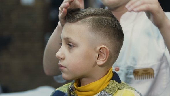 The Hairdresser Makes a Hairstyle for Her Little Client New Haircut for Boy Barbershop alt