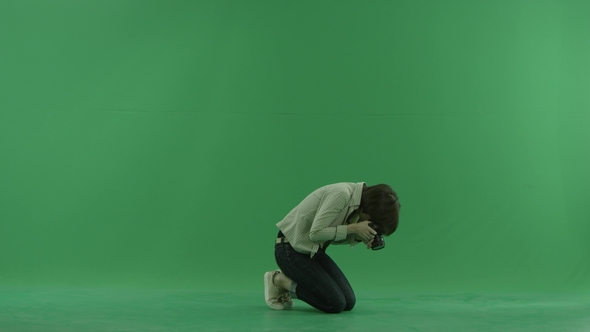 Sitting Young Woman Is Taking  Photos on the Right Hand Side on the Green Screen
