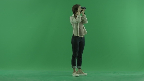 A Young Woman Is Taking Photos Upper Herself on the Right Hand Side on the Green Screen