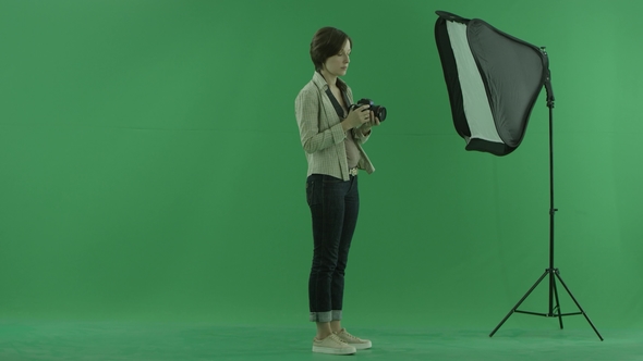 A Young Woman Is Trying To Use Camera for the Right Hand Side on the Green Screen