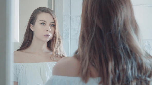 Young Beautiful Woman in Shirt Brushing Her Teeth in Bathroom. Beauty Concept