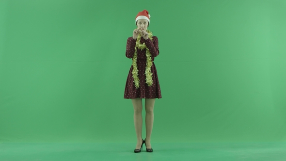 A Young Christmas Woman Is Showing Love To the Viewer on the Green Screen