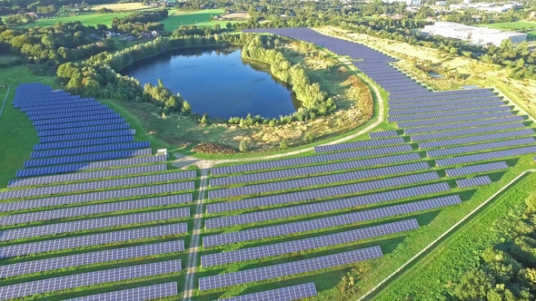 Aerial Shot of Solar Power Plant with Beautiful Lake in the Middle alt