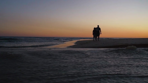 Senior Couple Walking Along Coast