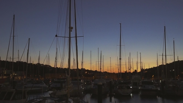 Rows of Boats at Pier in the Evening Against Sunset Skies