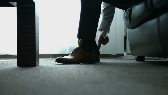 The Man Wears Shoes Tie the Laces on the Shoes Men's Style To Prepare for Work, To the Meeting