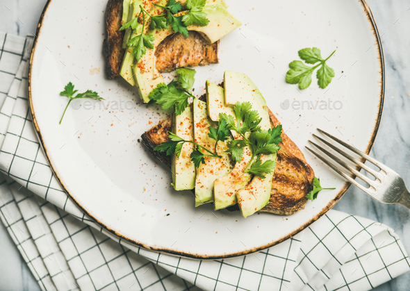 Flat-lay of avocado toast on plate, top view - Stock Photo - Images