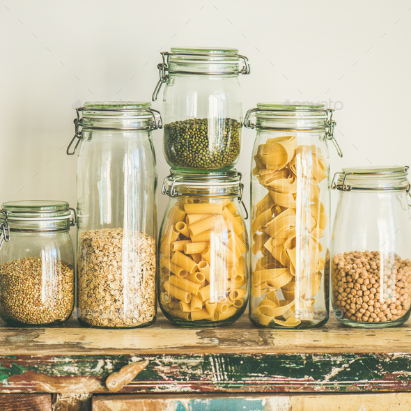 Uncooked cereals, grains, beans and pasta on table, square crop - Stock Photo - Images
