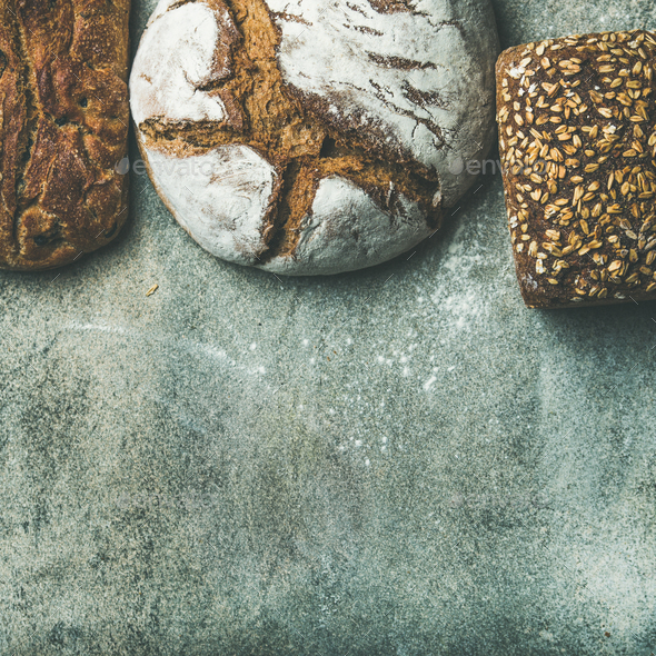 Top view of bread loaves over grey background, square crop - Stock Photo - Images