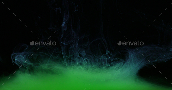 Green Ink Colors in Water Creating Liquid Art Shapes - Stock Photo - Images