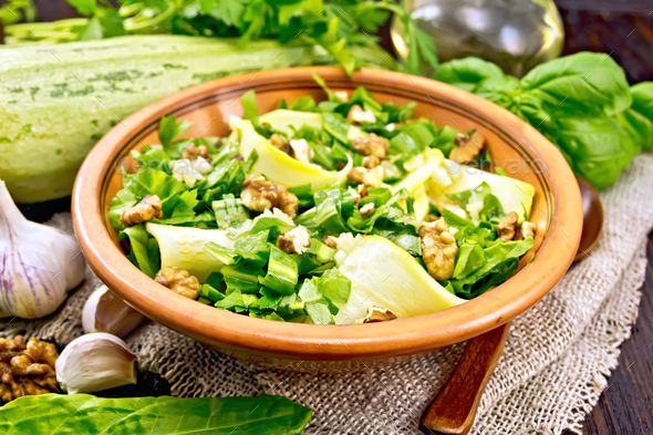 Salad with squash and sorrel in plate on dark board - Stock Photo - Images