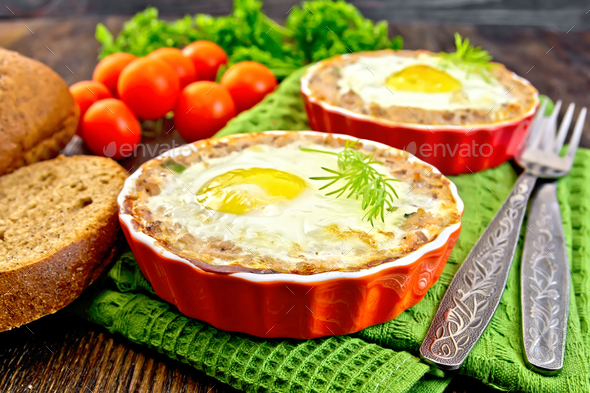 Tartlet meat with egg in pan on board - Stock Photo - Images