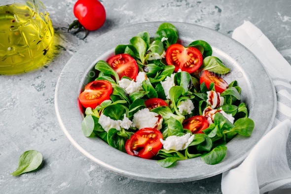 Download fresh salad bowl with green leaves, mozzarella, tomatoes ...