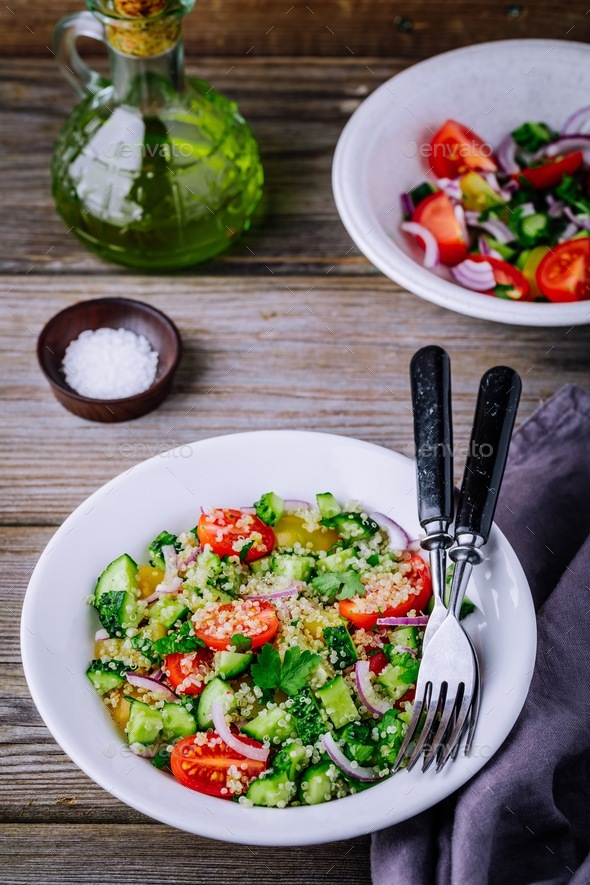 Download Quinoa Tabbouleh salad bowl with cucumbers, tomatoes, red ...
