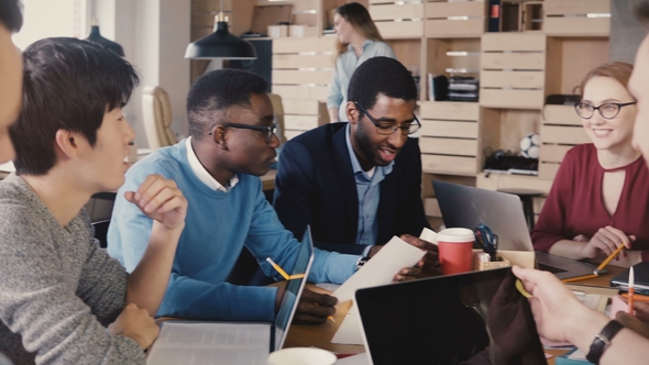 Female Team Leader Gives Directions To Colleagues. Healthy Multiethnic Team Discussing Business alt