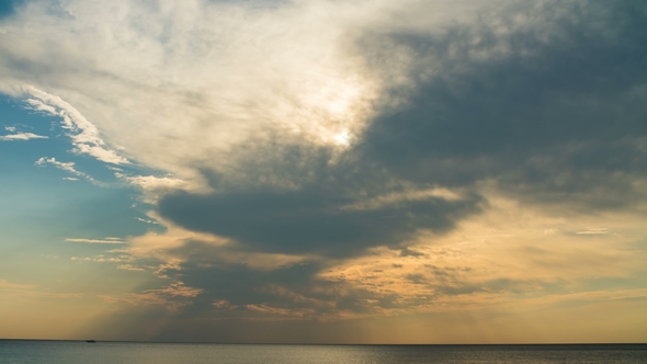 Sunset Through the Rainy Clouds Over Ocean. .