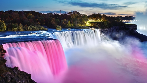 The Famous Niagara Falls in the Evening. Spotlights Illuminate the Waterfall Is Beautiful White and alt
