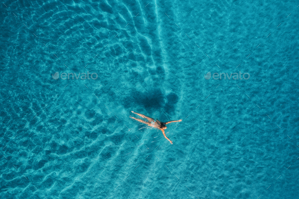 Aerial view of swimming woman in mediterranean sea - Stock Photo - Images