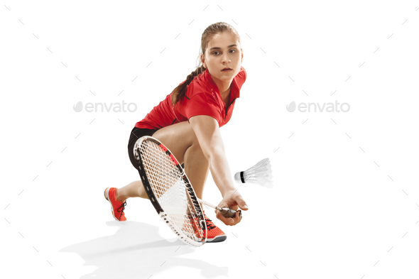 Young woman playing badminton over white background - Stock Photo - Images