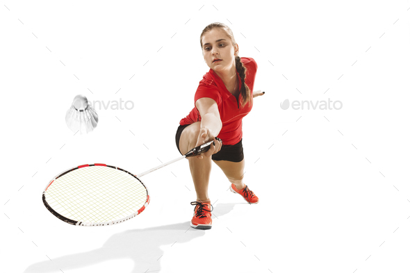 Young woman playing badminton over white background - Stock Photo - Images