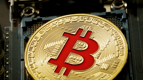 Gold Bit Coin BTC Coins on the Motherboard. Bitcoin Is a Worldwide Cryptocurrency alt