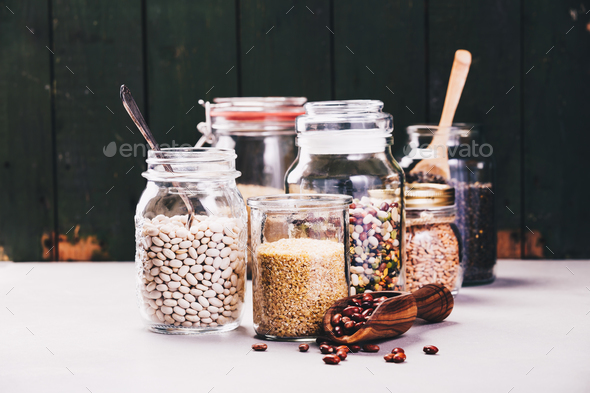 Glass jars with various legumes and grains - Stock Photo - Images