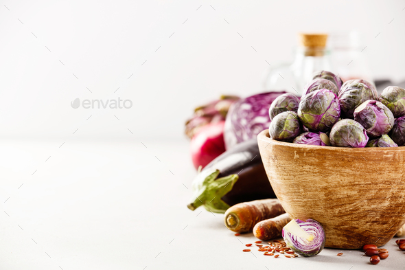 Purple Brussels sprouts in a wooden bowl - Stock Photo - Images