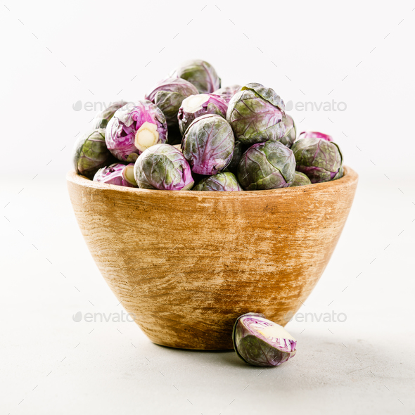 Purple Brussels sprouts in a wooden bowl - Stock Photo - Images
