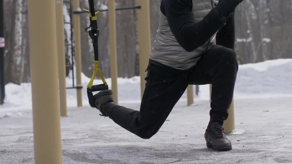 Man Training Squat Exercise and Jump Exercise with Fitness Expander Outdoor alt