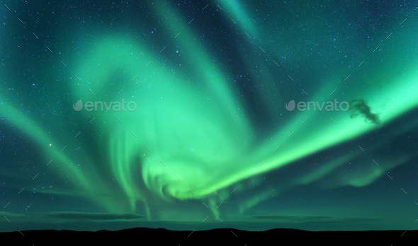 Aurora borealis and silhouette of hill. Lofoten islands, Norway. - Stock Photo - Images