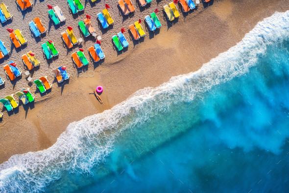Aerial view of lying woman with swim ring in the sea in Oludeniz - Stock Photo - Images