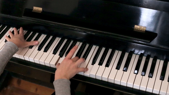 Woman's Hands Playing the Piano
