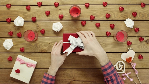 Male Gets Sticky Note with Sad Face As Holiday Gift in Box, Top View