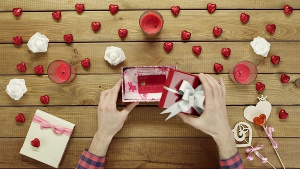 Man Gets Credit Card As Valentine Day Present in Gift Box, Top View