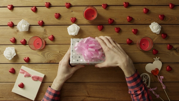 Amazed Man Gets Sticky Note with Question Mark As Holiday Gift, Top View alt