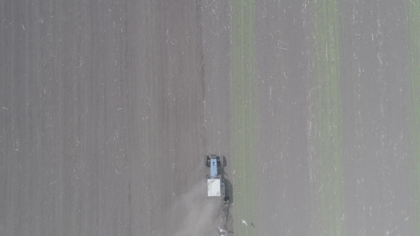 Aerial View of the Tractor Rides Across the Field and Sprues Seedlings