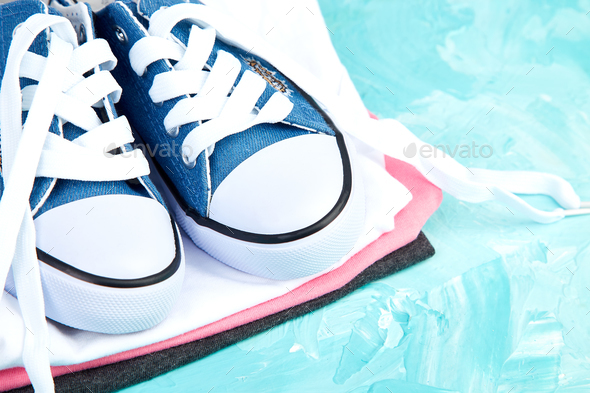 Flat lay of female sneakers shoes and tee - Stock Photo - Images