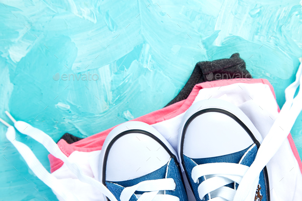 Flat lay of female sneakers shoes and tee - Stock Photo - Images