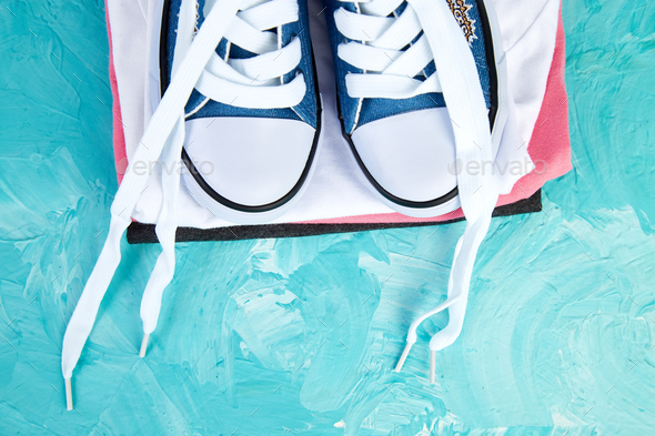 Flat lay of female sneakers shoes and tee - Stock Photo - Images