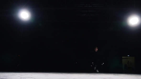Skater in a Black Suit with a Beautiful Contour Light Accelerates and Stops Abruptly alt