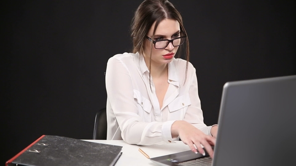 Beautiful Sexy Girl in Business Style Posing at Desk with Laptop