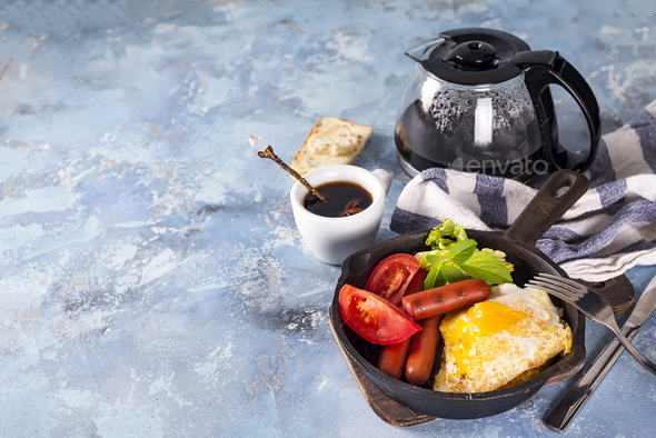 Homemade delicious american breakfast with fried egg, toast, sausage, vegetable, black coffee - Stock Photo - Images