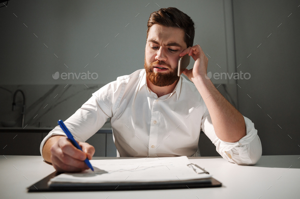 Portrait of a busy young businessman - Stock Photo - Images