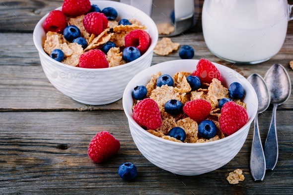 A healthy breakfast bowl. Whole grain cereal with fresh blueberries and raspberries Stock Photo by nblxer
