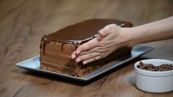 Pastry Chef Decorates a Chocolate Cake alt